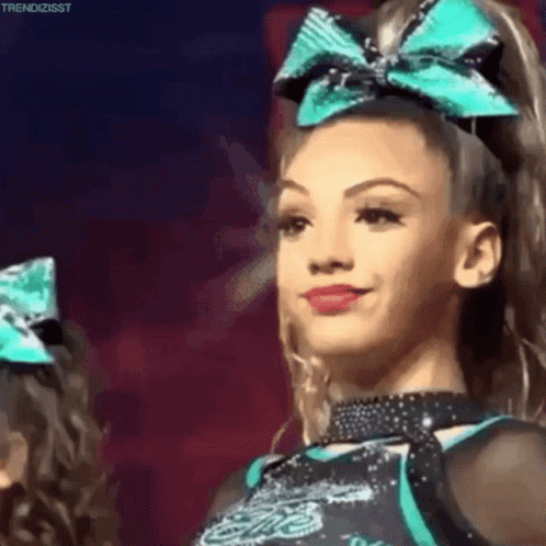 Smiling Cheerleader With Blue Bow