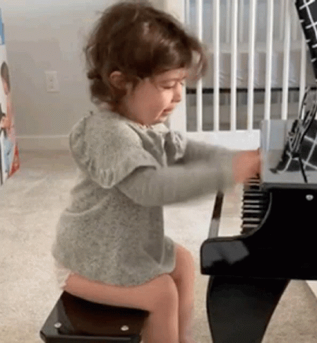 Smiling Cute Girl Playing Piano GIF