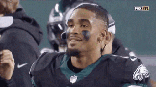 Smiling Football Player in Black Eagles Jersey