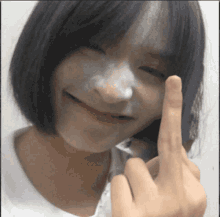 Smiling Girl Powdery Face Flipping Off GIF
