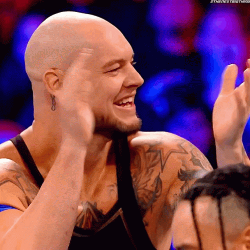 Smiling Man Clapping With Tattooed Arm GIF