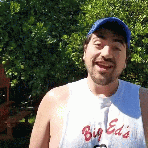 Smiling Man in Big Ed's Shirt Blue Hat