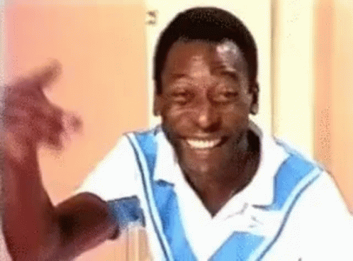 Smiling Man In Blue And White Shirt Waving GIF