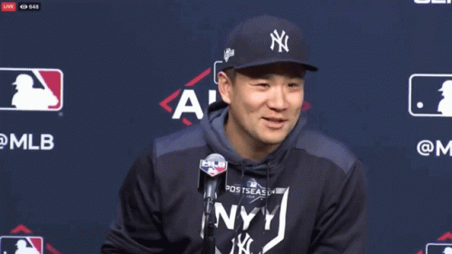 Smiling Man in NY Yankees Hat and Hoodie