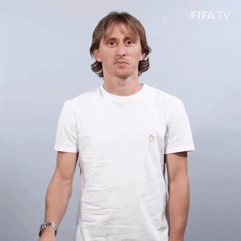Smiling Man in White T-Shirt Waving at FIFA TV Logo