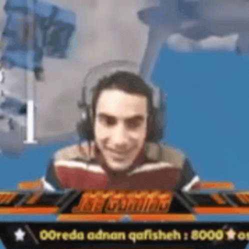 Smiling Man Playing Video Game With Headphones