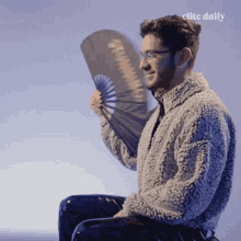 Smiling Man Using Fan GIF
