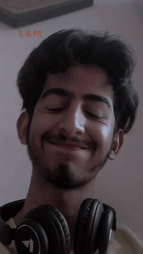 Smiling Man Wearing Headphones