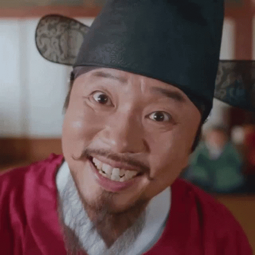 Smiling Man With Beard and Mustache in Red Shirt and Hat