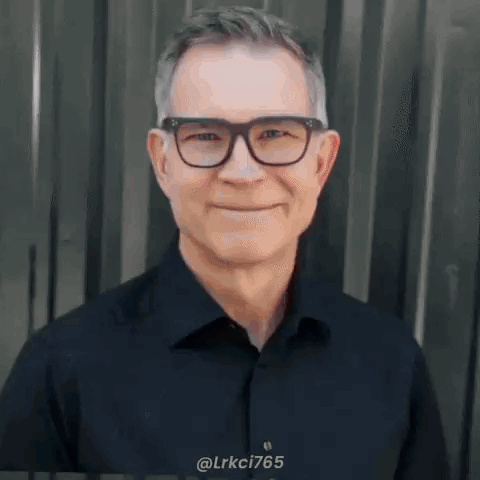 Smiling Man with Glasses and Black Shirt