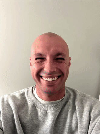 Smiling Man with Shaved Head