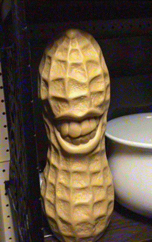 Smiling Peanut Statue On Shelf GIF