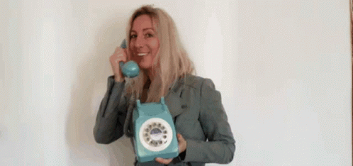 Smiling Woman Holding Blue Telephone GIF