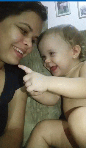Smiling Woman Holding Pointing Baby