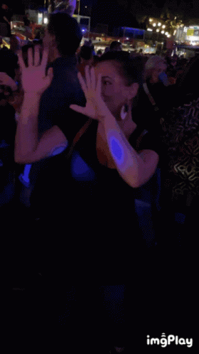 Smiling Woman in Front of Crowd