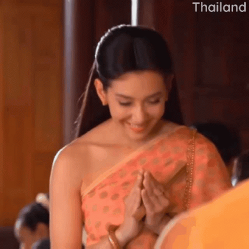 Smiling Woman In Traditional Costume Praying GIF