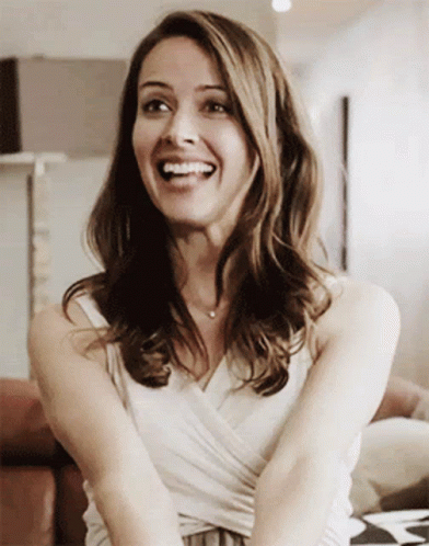 Smiling Woman in White Tank Top
