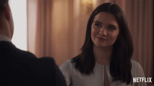 Smiling Woman Looking at Man With Netflix Logo