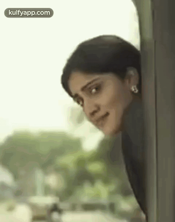 Smiling Woman Peeking From Train Window GIF