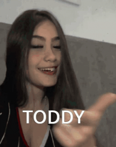 Smiling Woman with Long Hair Pointing Toddy