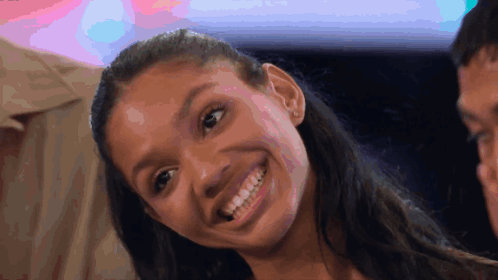 Smiling Woman with Ponytail and Colorful Background