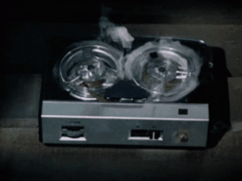 Smoke Is Coming Out Of A Tape Recorder That Is Sitting On The Floor GIF