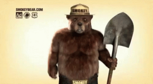 Smokey Bear Holding A Shovel And Wearing A Smokey Hat GIF