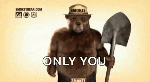 Smokey The Bear Is Wearing A Hat And Holding A Shovel And Says `` Only You '' . GIF