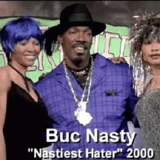 Snoop Dogg Is Posing For A Picture With Two Women While Wearing A Hat And A Necklace . GIF
