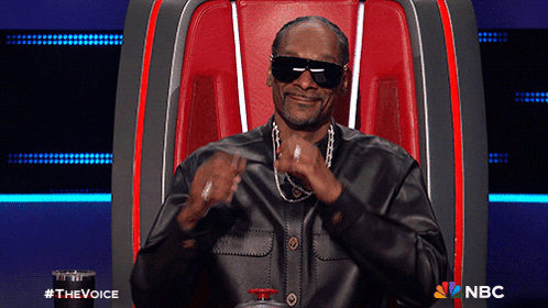 Snoop Dogg Is Sitting In A Chair With A Nbc Logo On The Bottom Right GIF