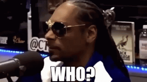 Snoop Dogg Is Sitting In Front Of A Microphone Wearing Sunglasses And Saying `` Who ? '' GIF