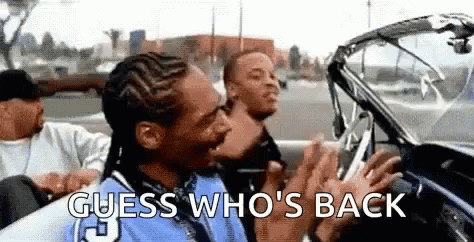 Snoop Dogg Is Sitting In The Back Seat Of A Car With Two Other Men And Says `` Guess Who 'S Back '' . GIF