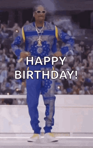 Snoop Dogg Is Wearing A Blue And Yellow Outfit And Dancing In Front Of A Crowd While Saying Happy Birthday . GIF