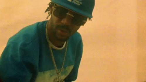 Snoop Dogg Is Wearing A Hat And Sunglasses . GIF