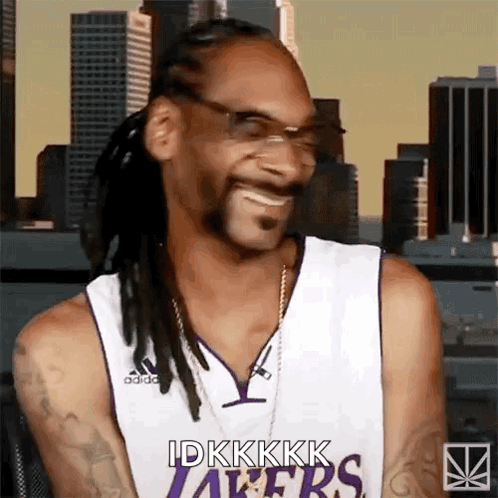Snoop Dogg Is Wearing A Lakers Jersey While Smiling GIF