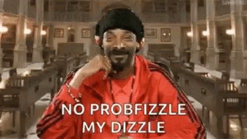 Snoop Dogg Is Wearing A Red Jacket And A Black Hat While Sitting In A Library . GIF