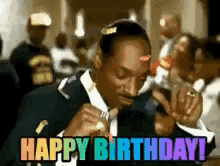 Snoop Dogg Is Wearing A Suit And Tie And Holding A Microphone And Says Happy Birthday . GIF