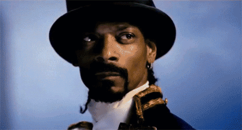 Snoop Dogg Is Wearing A Top Hat And A White Shirt GIF