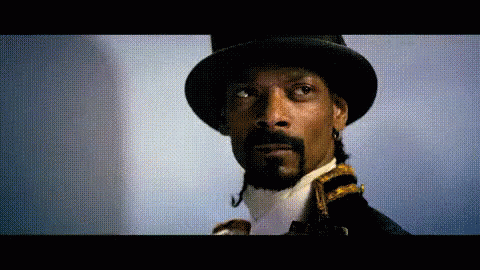 Snoop Dogg Is Wearing A Top Hat And Tie GIF