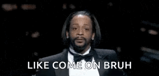 Snoop Dogg Is Wearing A Tuxedo And Smoking A Cigarette . GIF