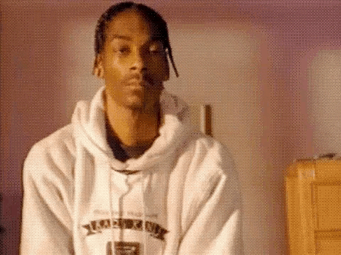 Snoop Dogg Is Wearing A White Hoodie And A White Robe . GIF