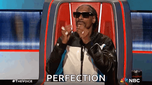 Snoop Dogg Sitting with Hands in Pockets
