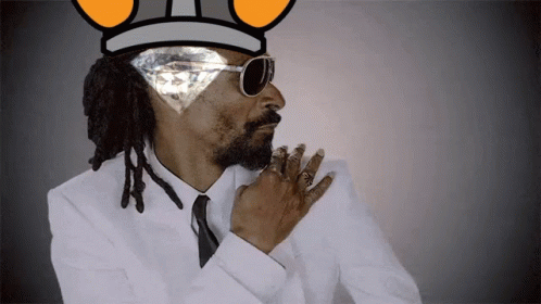 Snoop Dogg Wearing A Crown And Sunglasses With A Diamond In His Eye GIF