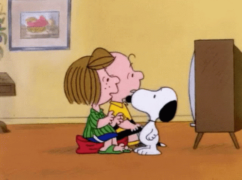 Snoopy And Charlie Brown Are Sitting On The Floor Watching A Television . GIF