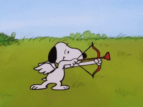 Snoopy Holding A Bow And Arrow In A Field GIF
