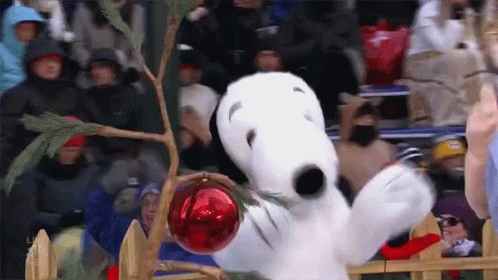 Snoopy Holding Red Ornament in Christmas Tree