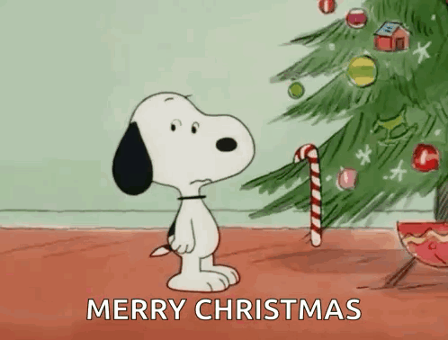 Snoopy Is Holding A Candy Cane In Front Of A Christmas Tree And Says Merry Christmas . GIF