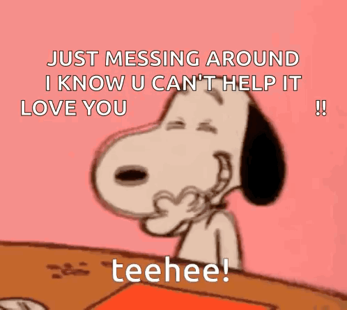 snoopy is sitting at a table and making a heart with his hands and says just messing around .