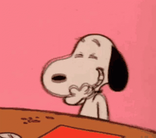 Snoopy Is Sitting At A Table With His Eyes Closed And His Hand On His Face . GIF
