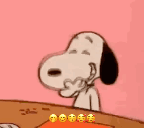 Snoopy Is Sitting At A Table With His Eyes Closed And Making A Funny Face . GIF